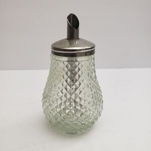 Glass sugar dispenser with a metal lid and spout. 206